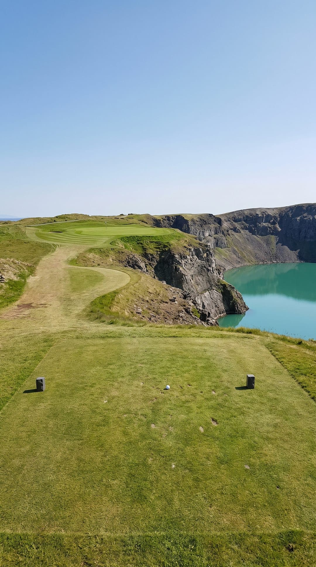 AI-imagined golf hole: a long par 3 along the rim of a flooded volcanic crater