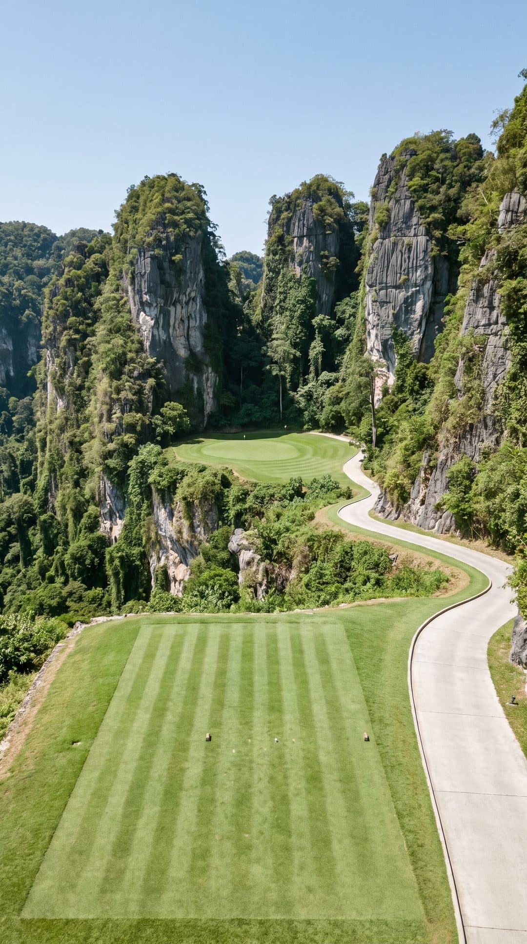 AI-imagined golf hole: a par 3 from a clifftop tee down to a green on the jungle floor between limestone towers